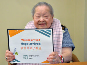 Senior smiling after COVID-19 vaccination